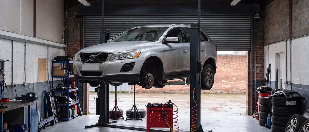 A car raised on a two-post ramp in the Tyneline Automotive workshop during preparation
